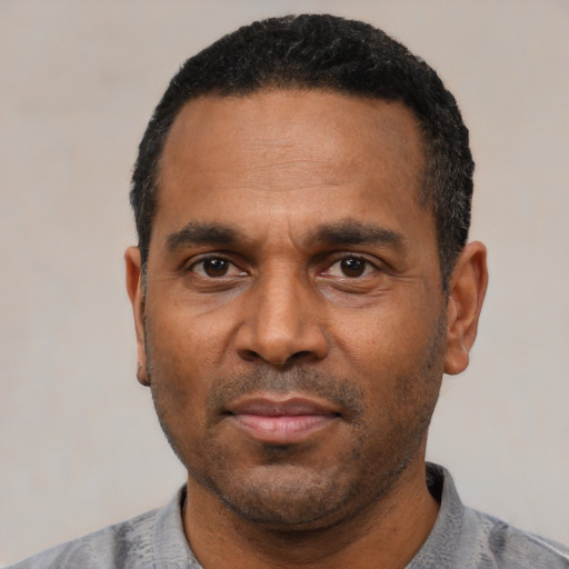 Neutral latino adult male with short  black hair and brown eyes