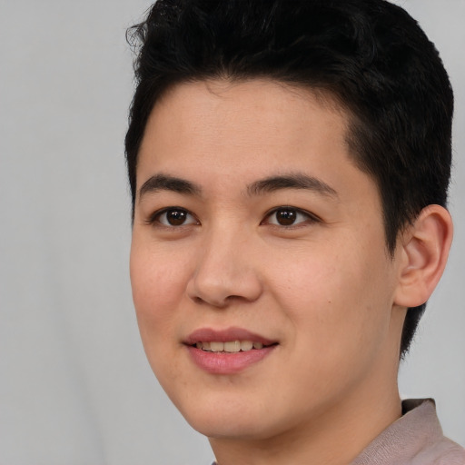 Joyful latino young-adult male with short  brown hair and brown eyes
