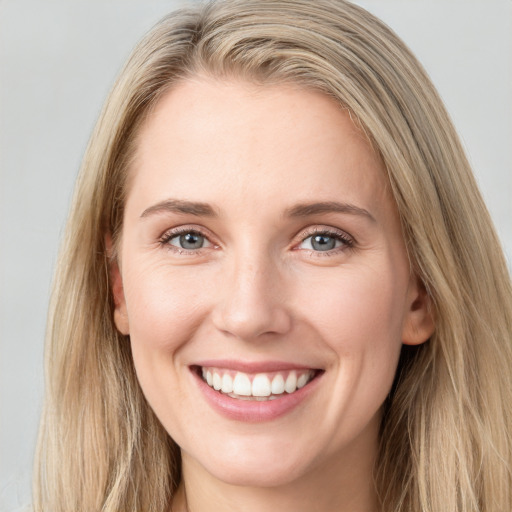 Joyful white young-adult female with long  brown hair and blue eyes