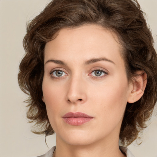 Joyful white young-adult female with medium  brown hair and green eyes