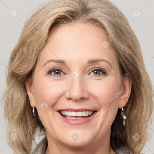 Joyful white adult female with medium  brown hair and grey eyes