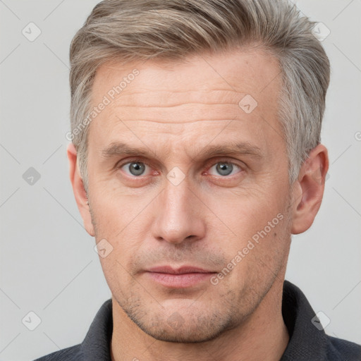 Neutral white adult male with short  brown hair and grey eyes