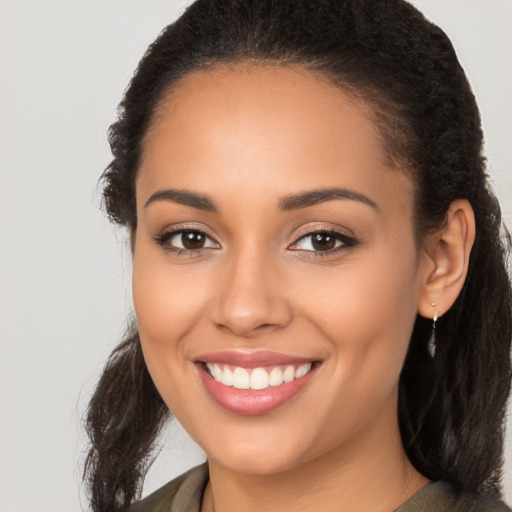 Joyful latino young-adult female with long  brown hair and brown eyes