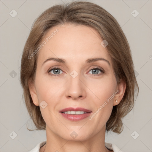 Joyful white adult female with medium  brown hair and grey eyes