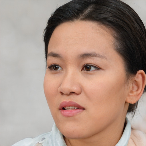 Joyful asian young-adult female with short  brown hair and brown eyes