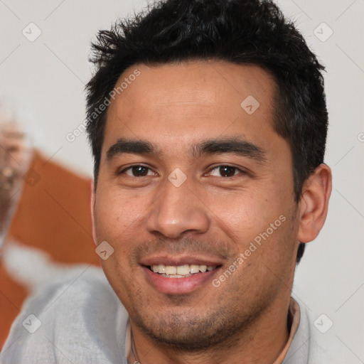 Joyful white young-adult male with short  black hair and brown eyes