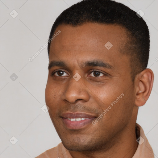 Joyful black young-adult male with short  black hair and brown eyes