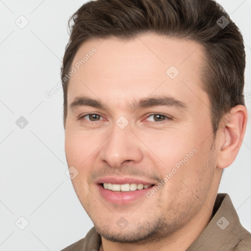 Joyful white young-adult male with short  brown hair and brown eyes