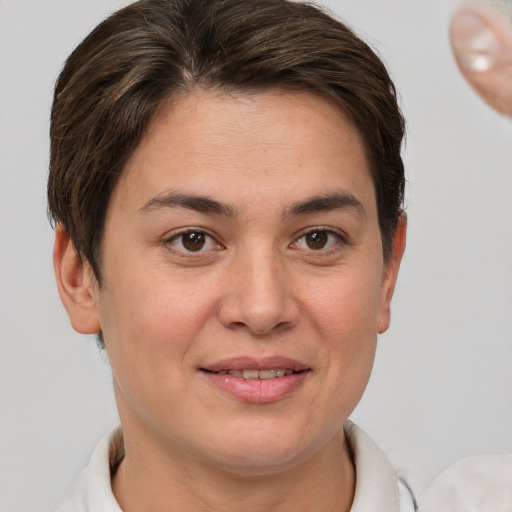 Joyful white young-adult female with short  brown hair and brown eyes