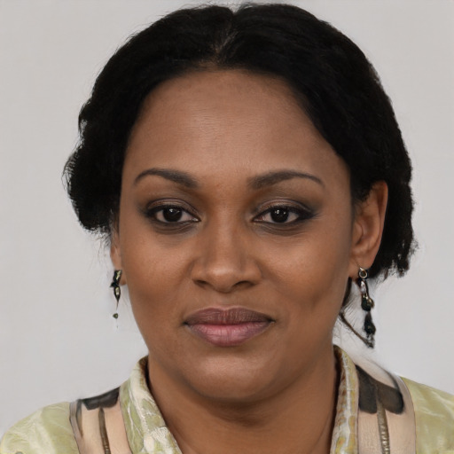 Joyful black adult female with short  black hair and brown eyes