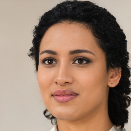 Joyful latino young-adult female with medium  black hair and brown eyes