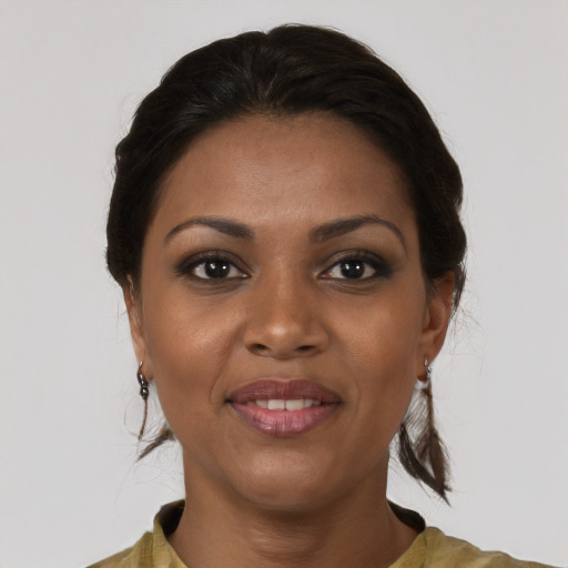 Joyful black young-adult female with medium  brown hair and brown eyes