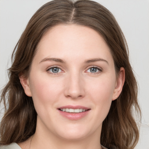 Joyful white young-adult female with long  brown hair and grey eyes