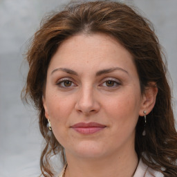 Joyful white adult female with medium  brown hair and brown eyes