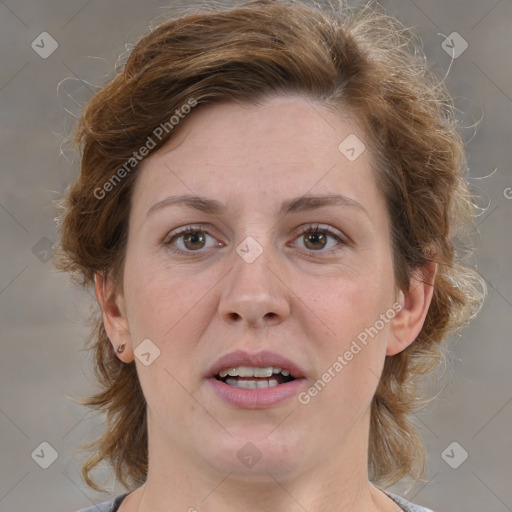 Joyful white adult female with medium  brown hair and grey eyes