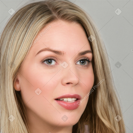 Joyful white young-adult female with long  brown hair and blue eyes