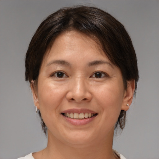 Joyful white adult female with medium  brown hair and brown eyes