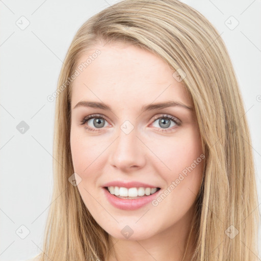 Joyful white young-adult female with long  brown hair and green eyes