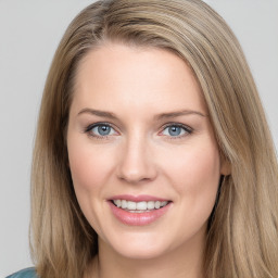 Joyful white young-adult female with long  brown hair and blue eyes