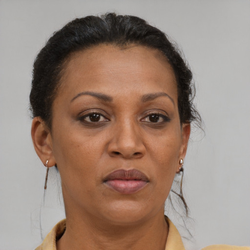 Joyful black adult female with short  brown hair and brown eyes