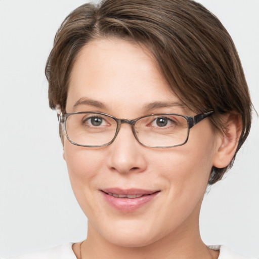 Joyful white adult female with medium  brown hair and grey eyes