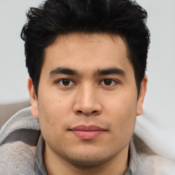 Joyful latino young-adult male with short  brown hair and brown eyes