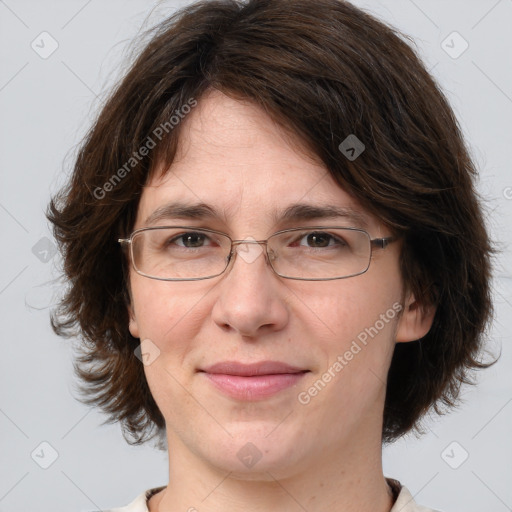 Joyful white adult female with medium  brown hair and brown eyes