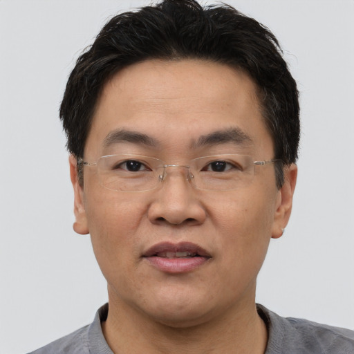 Joyful asian adult male with short  brown hair and brown eyes