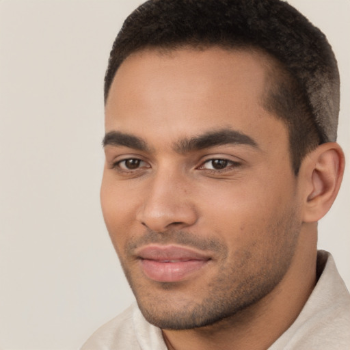 Joyful latino young-adult male with short  brown hair and brown eyes