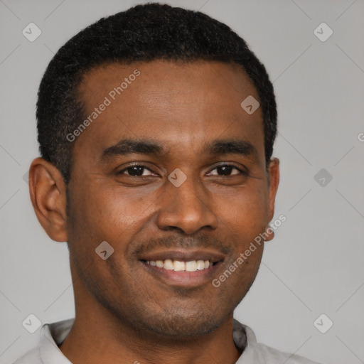 Joyful black young-adult male with short  black hair and brown eyes