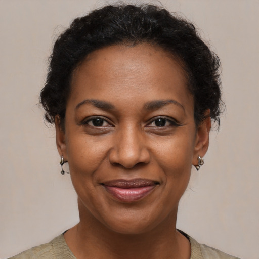 Joyful black adult female with short  brown hair and brown eyes