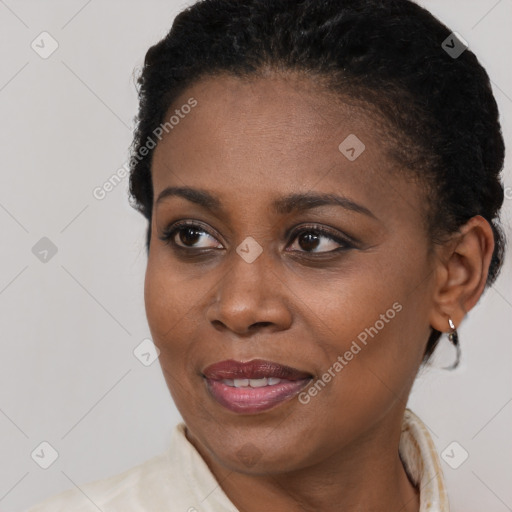 Joyful black young-adult female with short  brown hair and brown eyes