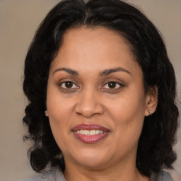 Joyful latino adult female with medium  brown hair and brown eyes