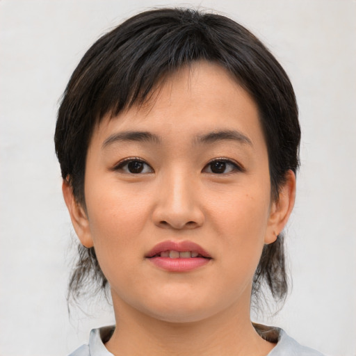 Joyful asian young-adult female with medium  black hair and brown eyes