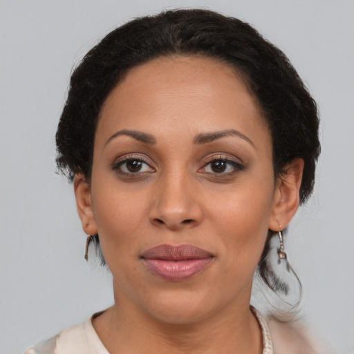 Joyful black young-adult female with medium  brown hair and brown eyes