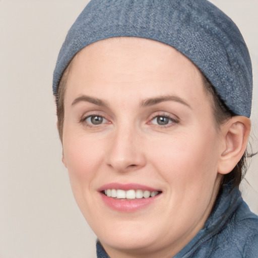 Joyful white young-adult female with short  brown hair and blue eyes