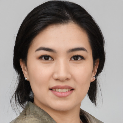 Joyful asian young-adult female with medium  black hair and brown eyes
