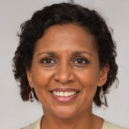Joyful black adult female with medium  brown hair and brown eyes