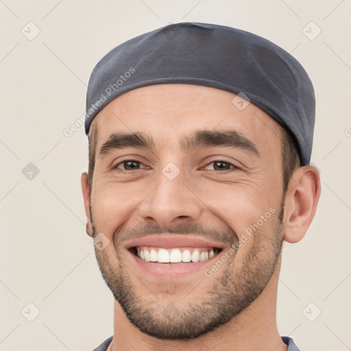 Joyful white young-adult male with short  black hair and brown eyes