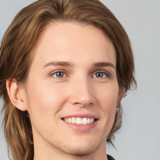 Joyful white young-adult female with medium  brown hair and green eyes