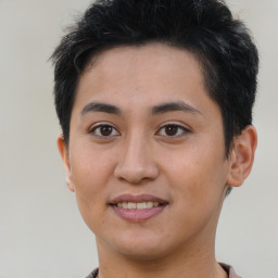 Joyful latino young-adult male with short  brown hair and brown eyes