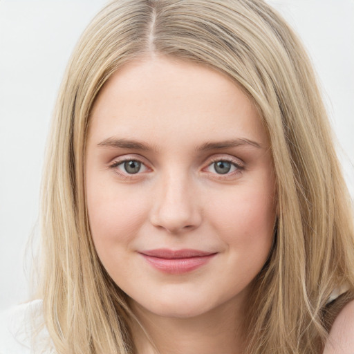 Joyful white young-adult female with long  brown hair and blue eyes