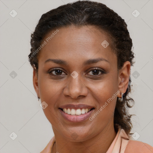 Joyful black young-adult female with short  brown hair and brown eyes