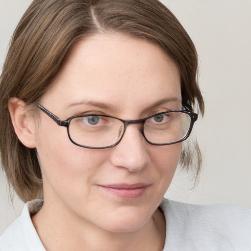 Joyful white young-adult female with medium  brown hair and blue eyes