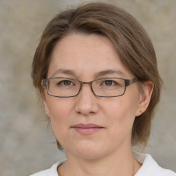 Joyful white adult female with medium  brown hair and grey eyes