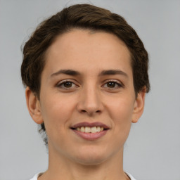 Joyful white young-adult female with short  brown hair and brown eyes