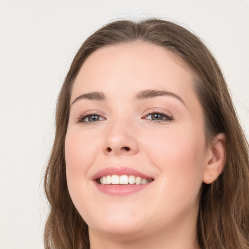 Joyful white young-adult female with long  brown hair and grey eyes