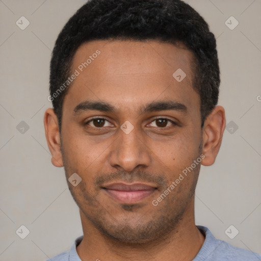 Joyful black young-adult male with short  black hair and brown eyes