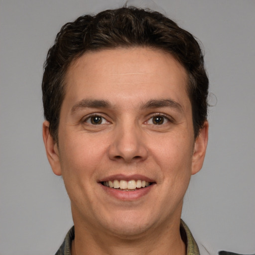 Joyful white adult male with short  brown hair and brown eyes