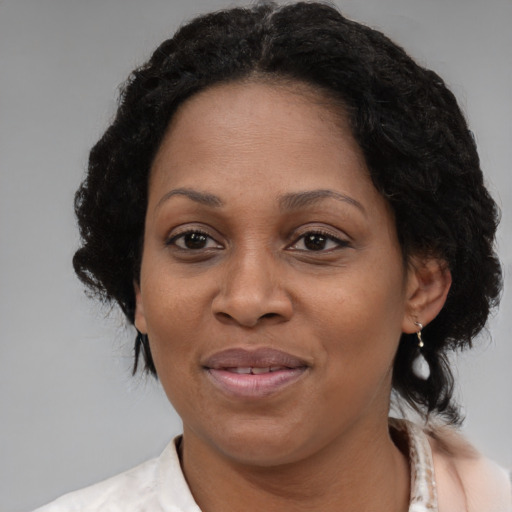 Joyful black adult female with medium  brown hair and brown eyes